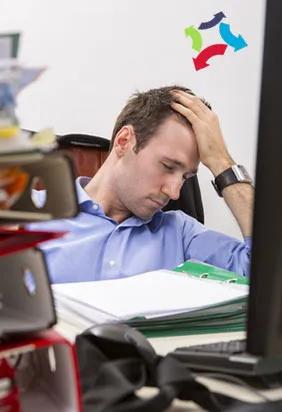Homme épuisé devant une pile de dossiers